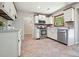 Well-lit kitchen featuring stainless steel appliances, light colored cabinets, and unique tiled flooring at 588 Benson Hurst Dr, Mableton, GA 30126
