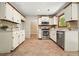 Charming kitchen with stainless steel appliances, light colored cabinets, and unique tiled flooring at 588 Benson Hurst Dr, Mableton, GA 30126