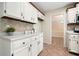 Cozy kitchen with white cabinets, breakfast nook, tiled backsplash, and an inviting atmosphere, perfect for casual dining at 588 Benson Hurst Dr, Mableton, GA 30126