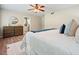 Comfortable main bedroom with a ceiling fan, hardwood floors, and a stylish dresser with a mirror at 588 Benson Hurst Dr, Mableton, GA 30126