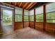 Cozy sunroom with wood paneling and multiple windows offering serene views at 588 Benson Hurst Dr, Mableton, GA 30126