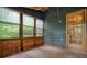 Well-lit sunroom with wooden walls and a doorway, providing views of the outdoors at 588 Benson Hurst Dr, Mableton, GA 30126