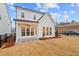 This backyard features a covered patio, and lush landscaping at 651 Summitt Hill Way, Cumming, GA 30040