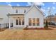 This backyard features a covered patio, and lush landscaping at 651 Summitt Hill Way, Cumming, GA 30040