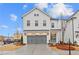 Charming two-story home with a gray two-car garage and a welcoming teal-colored front door at 651 Summitt Hill Way, Cumming, GA 30040