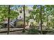 Back exterior view with a tiered deck, lush greenery, and an inviting outdoor space at 7235 Compton Cir, Cumming, GA 30040