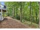 Backyard featuring mature trees, landscaping, and a tranquil setting at 7235 Compton Cir, Cumming, GA 30040
