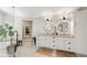 Modern bathroom with a double vanity, granite counters, decorative mirrors, and luxury tiling at 7235 Compton Cir, Cumming, GA 30040