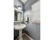 Small half-bath with a pedestal sink, medicine cabinet and gray walls at 7235 Compton Cir, Cumming, GA 30040