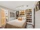 Bedroom featuring built-in bookshelves, a double bed, and access to an en-suite bathroom at 7235 Compton Cir, Cumming, GA 30040