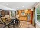 A dining area with wooden cabinets, a table with chairs, and windows with a view at 7235 Compton Cir, Cumming, GA 30040