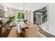 Inviting dining room with wainscoting and large window view with a long rustic wood table at 7235 Compton Cir, Cumming, GA 30040