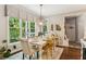 Dining area with an interesting light fixture, large windows, and view of the backyard at 7235 Compton Cir, Cumming, GA 30040