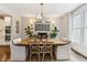Elegant dining room featuring exposed brick, a modern chandelier, and a large wooden table at 7235 Compton Cir, Cumming, GA 30040