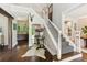 Elegant foyer with hardwood floors, staircase, statement mirror, and stylish decor at 7235 Compton Cir, Cumming, GA 30040
