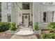 Inviting front porch with double doors, potted plants, and stylish decor, creating a warm welcome at 7235 Compton Cir, Cumming, GA 30040