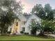 Charming, white two-story home with manicured lawn and mature trees at 7235 Compton Cir, Cumming, GA 30040
