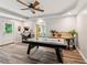 Large game room featuring an air hockey table, an arcade game, and natural lighting at 7235 Compton Cir, Cumming, GA 30040