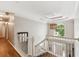 Hallway with hardwood floors, white walls, and view of the front entrance at 7235 Compton Cir, Cumming, GA 30040