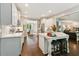 Bright, airy kitchen with white cabinets, marble countertops, stainless appliances, and a center island with seating at 7235 Compton Cir, Cumming, GA 30040