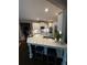 Modern kitchen with a large island, white cabinets, and stainless steel appliances at 7235 Compton Cir, Cumming, GA 30040