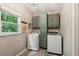 Laundry room with a window, cabinetry, a washer and dryer at 7235 Compton Cir, Cumming, GA 30040