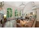 Spacious living room with large windows overlooking a wooded yard, a stone fireplace, and vaulted ceilings at 7235 Compton Cir, Cumming, GA 30040