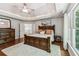 This main bedroom boasts a tray ceiling, hardwood floors, and ample natural light from the windows at 7235 Compton Cir, Cumming, GA 30040