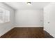 A bedroom features hardwood floors, trim work, and a window offering natural light, creating a clean, bright and inviting space at 115 Biscayne Nw Dr # F1, Atlanta, GA 30309