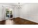 Dining area with hardwood floors, chandelier lighting, and sliding door to patio at 115 Biscayne Nw Dr # F1, Atlanta, GA 30309