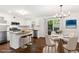 Open kitchen and dining area with stainless steel appliances, granite countertops, and a modern chandelier at 115 Biscayne Nw Dr # F1, Atlanta, GA 30309