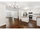 Open floor plan with hardwood floors, chandelier and kitchen with island at 115 Biscayne Nw Dr # F1, Atlanta, GA 30309