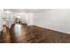 Open-concept living area with hardwood floors, modern lighting, and access to the kitchen and outdoor patio at 115 Biscayne Nw Dr # F1, Atlanta, GA 30309