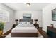 Bedroom showcasing neutral tones, complementing the wood floors and is decorated with lamps, a bed and plants at 115 Biscayne Nw Dr # F1, Atlanta, GA 30309