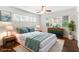 Staged bedroom featuring two windows, hardwood floors and modern decor at 115 Biscayne Nw Dr # F1, Atlanta, GA 30309