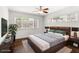 Modern bedroom features a ceiling fan, a bed with stylish headboard, dresser and two large windows at 115 Biscayne Nw Dr # F1, Atlanta, GA 30309