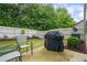 Backyard featuring a patio area with seating, a grill, and manicured landscaping at 2860 Cooper Brook Dr, Snellville, GA 30078