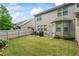 A well-manicured backyard with a privacy fence, patio seating, and lush lawn offers a serene outdoor living space at 2860 Cooper Brook Dr, Snellville, GA 30078