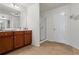 Bathroom featuring wood cabinets, granite countertops, tiled flooring, and a glass-enclosed shower at 2860 Cooper Brook Dr, Snellville, GA 30078