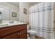 Bathroom with a single vanity, toilet, and a shower with a curtain, offering a functional space at 2860 Cooper Brook Dr, Snellville, GA 30078