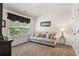 Bedroom featuring a comfortable sofa, side table, and a window with natural light at 2860 Cooper Brook Dr, Snellville, GA 30078