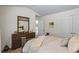 Bedroom featuring a well-lit space with a bed, dresser, and closet doors at 2860 Cooper Brook Dr, Snellville, GA 30078
