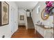 Inviting entryway with hardwood floors, staircase, and elegant console table at 2860 Cooper Brook Dr, Snellville, GA 30078