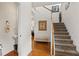 Bright entryway featuring hardwood floors, a staircase, and a convenient powder room at 2860 Cooper Brook Dr, Snellville, GA 30078