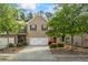 Charming brick townhome with a two-car garage and well-manicured landscaping at 2860 Cooper Brook Dr, Snellville, GA 30078