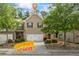 Charming brick townhome with a two-car garage and well-manicured landscaping at 2860 Cooper Brook Dr, Snellville, GA 30078