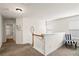 Upstairs landing features carpet, railing, and view of bathroom and seating area at 2860 Cooper Brook Dr, Snellville, GA 30078