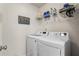 Convenient laundry room with modern washer and dryer, storage shelves, and 'Love and Laundry' decor at 2860 Cooper Brook Dr, Snellville, GA 30078