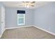 Cozy carpeted bedroom featuring a ceiling fan and a window with natural light at 4000 Mcpherson Drive Dr, Acworth, GA 30101