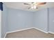 Simple carpeted bedroom with a ceiling fan and neutral paint at 4000 Mcpherson Drive Dr, Acworth, GA 30101